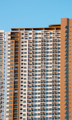 Condominium or apartment building with blue sky background