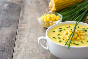 Corn soup in white bowl on wooden background.Copyspace
