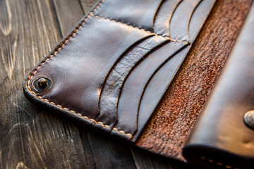 Brown leather wallet on wooden table, Old
