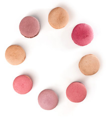 Pastel coloured macarons forming a frame on white