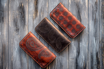 Group old Wallet of Leather skin on wooden background