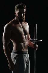 Naked athletic man with barbell