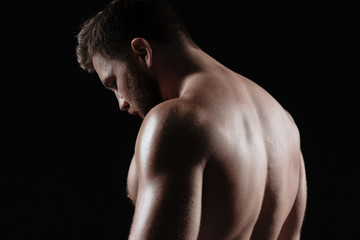 Obraz na płótnie Canvas Side view of naked muscular man