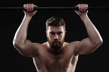 Fototapeta na wymiar Muscular man on to horizontal bar