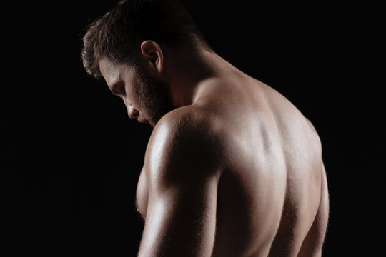 Side view of naked muscular man