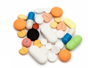 Tablets, different medicines lie on white background, isolated.