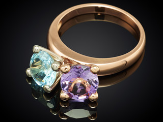Golden ring with gemstone isolated on black background