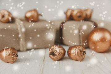 Christmas composition.Present boxes with twine and craft paper,golden acorns and copper balls.White wooden table.