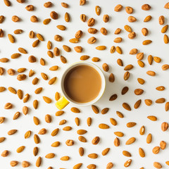 Colourful bright pattern made of almonds with coffee cup.