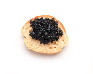 piece of white bread with black caviar on white background