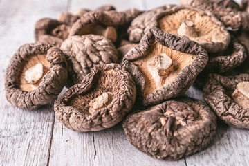 Close up of Dry Shiitake mushrooms on wooden table. 