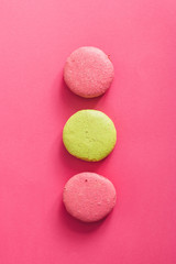 Colorful macaroons cakes on pink background
