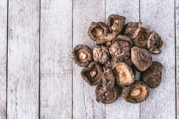 Dry Shiitake mushrooms on wooden table.