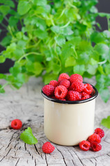 Fresh raspberries in cup and milk