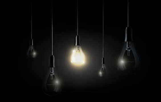 Glowing light bulb is hanging between a lot of turned off light bulbs on dark black background, copyspace, transparent vector