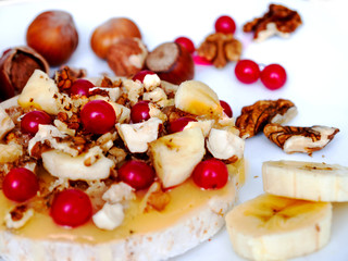 Sweet rice cakes with honey, nuts, banana and berry viburnum