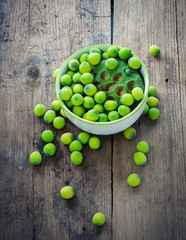 Lotus seeds in white bowl on wood background