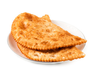 Two Chebureks on white plate isolated with clipping path. Front view. Pasties.