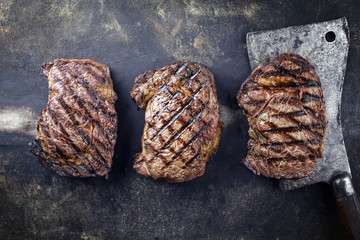 Barbecue Rib-Eye Steaks on old Metall Sheet