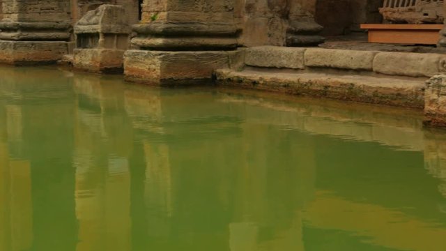 A low panoramic shot of the thermal waters of the Roman spa complex in Bath, UK. The temple was established in 60-70 AD and the bathing complex was gradually built up over the following 300 years
