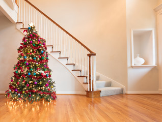 Colorfully decorated Christmas in home on wooden oak floor