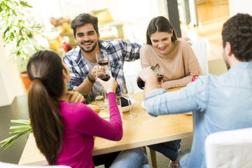 Young people sitting by the table