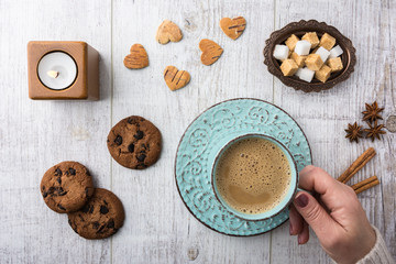  Women drinking coffee with milk and eating cookies top view