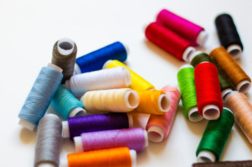 Fototapeta na wymiar multicolored spools of thread on white background