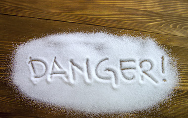 DANGER written on pile of sugar