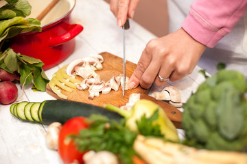 Slicing of fresh champignons in the kitchen