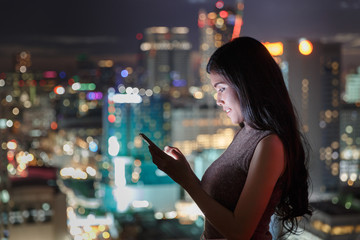 Woman On Smartphone With City View