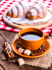 Coffee cup and coffee beans on table