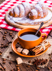 Coffee cup and coffee beans on table