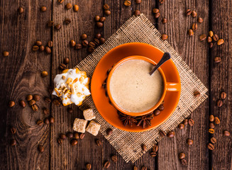 Coffee cup and coffee beans on table