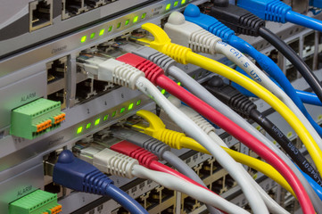 Angle view of telecommunications rack with switches and colored