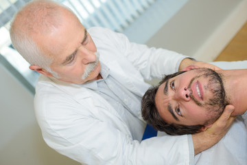 Fototapeta premium man receiving head massage in medical office
