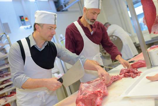 Butchers chopping meat
