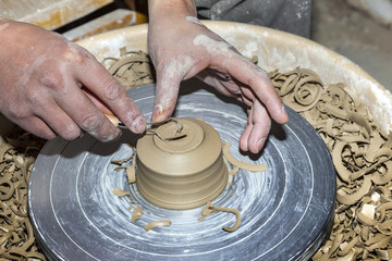 hands working on pottery wheel