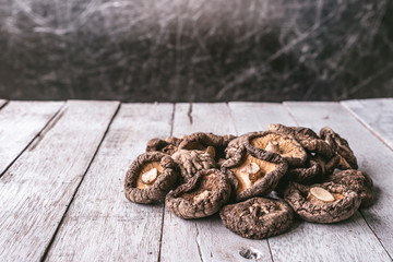 Dry Shiitake mushrooms on wooden table.