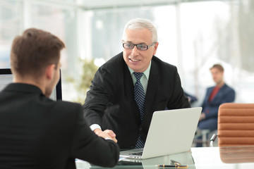 Businessman by handshake invites to cooperation.