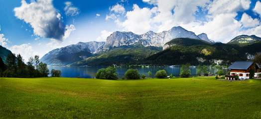 beautiful mountains landscape with water sea and green gras daylight daytime