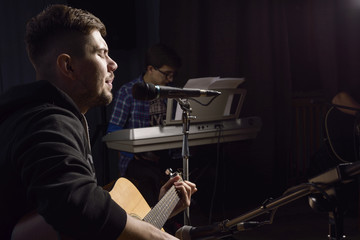 man plays guitar and sings