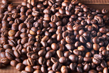 Coffee beans on the wooden background