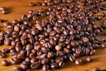 Roasted coffee beans on the wooden background
