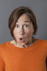 amazed middle aged woman with mouth opened expressing surprise