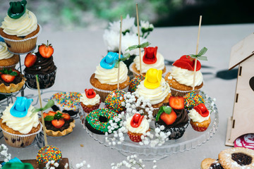 Candy bar cupcakes decorated in cowboy style. Close-up.