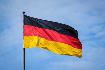 German national flag in against blue sky