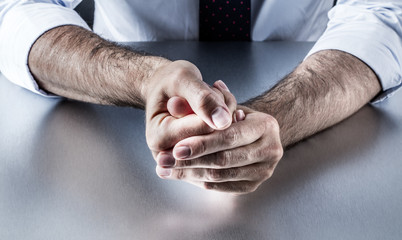Fototapeta premium bothered businessman hands holding fingers with tension expressing controlled exasperation