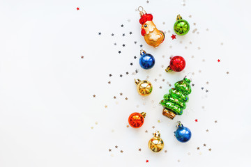 Christmas background with decorations. New Year 2017 symbol - Fire Rooster.Shiny colorful balls, fir tree and star confetti. Flay lay, top view.
