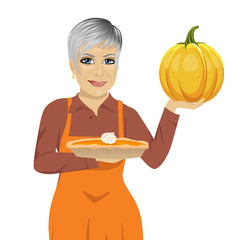 senior woman holding freshly baked homemade pumpkin pie